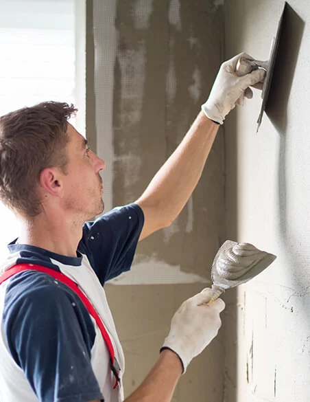 Plasterer skimming an office wall ready for decoration