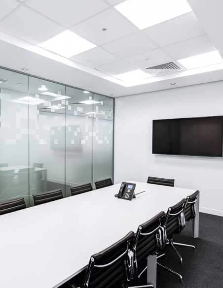 Refurbished meeting room with glass partition and media wall