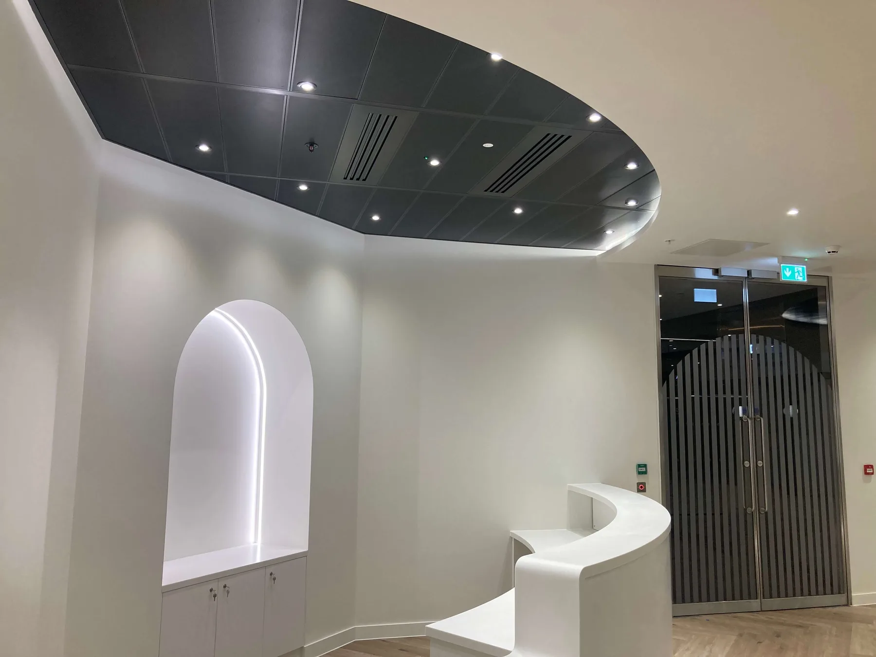 Curved reception desk and feature ceiling built by Sapphire Refurbishments