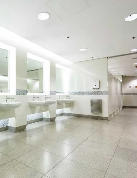 Refurbished commercial washroom with cubicles and sinks