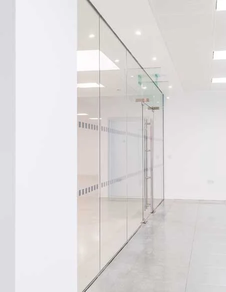 Frameless glass partition installed in a modern office