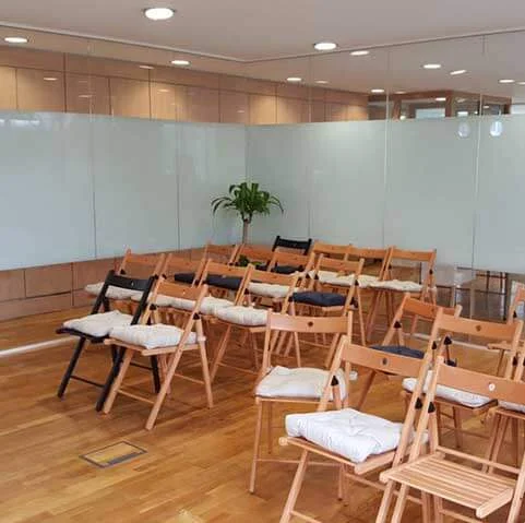 Meeting space with glass partition wall and timber floor